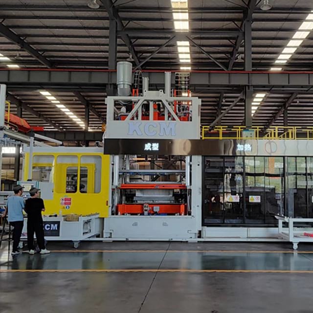 Modern industrial facility operating heavy plastic manufacturing equipment for thermoforming